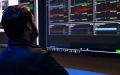 Man looking at data on monitors